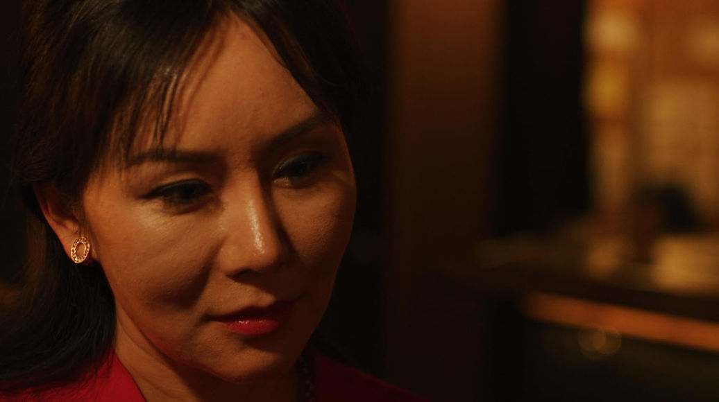 A close-up of an older Asian woman, actress Crystal Huang